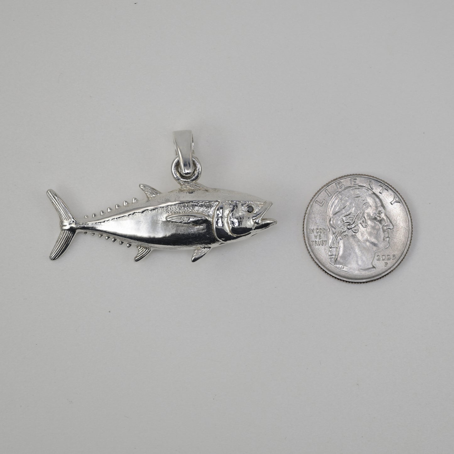 Blackfin Tuna made in sterling silver size referenced next to a quarter