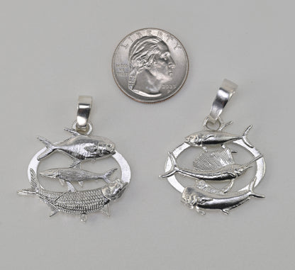 Two silver fish pendants displayed side-by-side next to a US quarter coin for scale, on a neutral gray background.