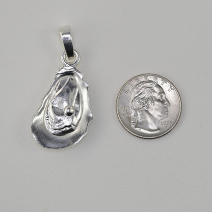 Oyster pendant size reference next to a quarter