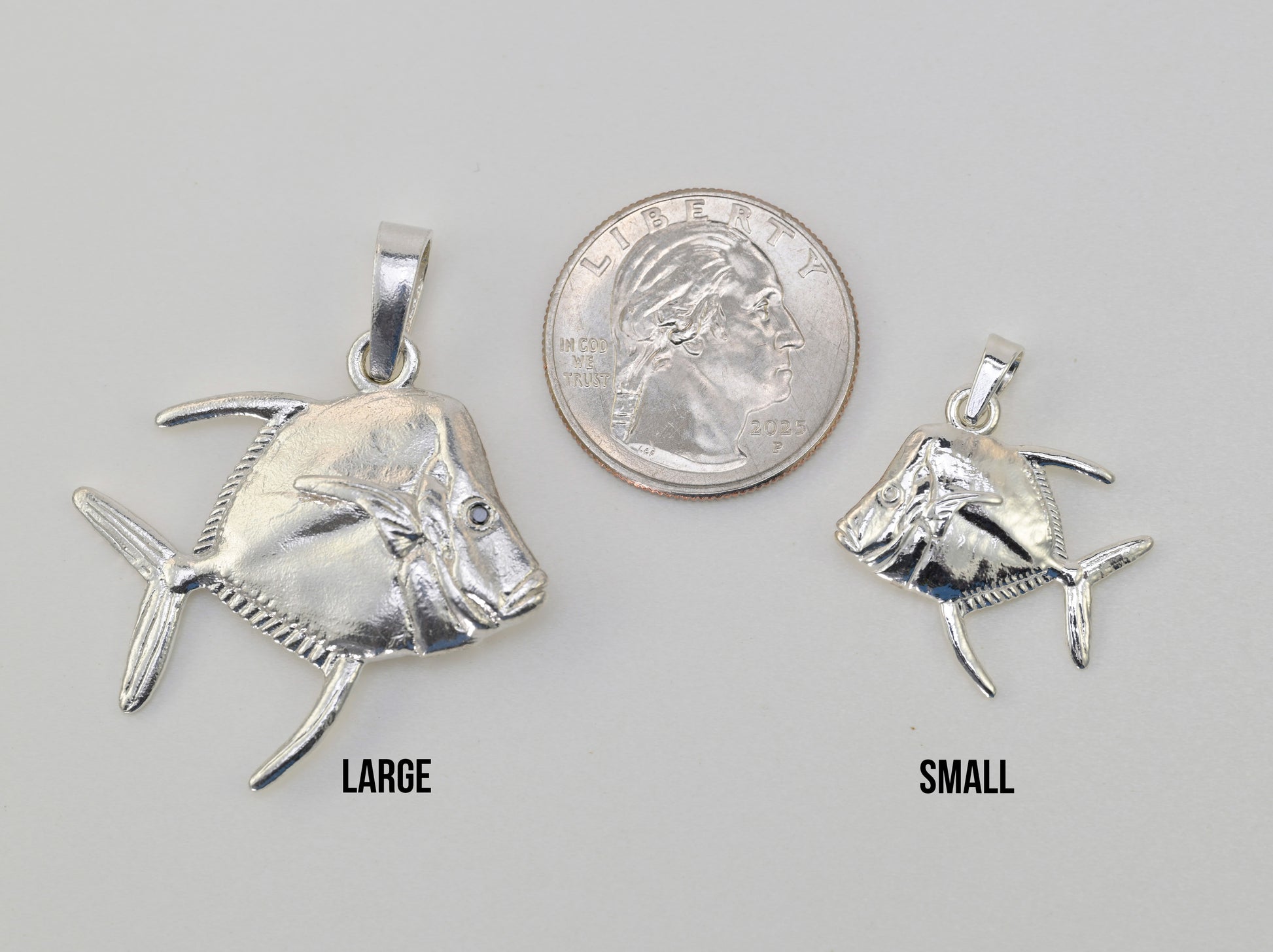 Lookdown fish pendant made in sterling silver size reference photo next to a quarter